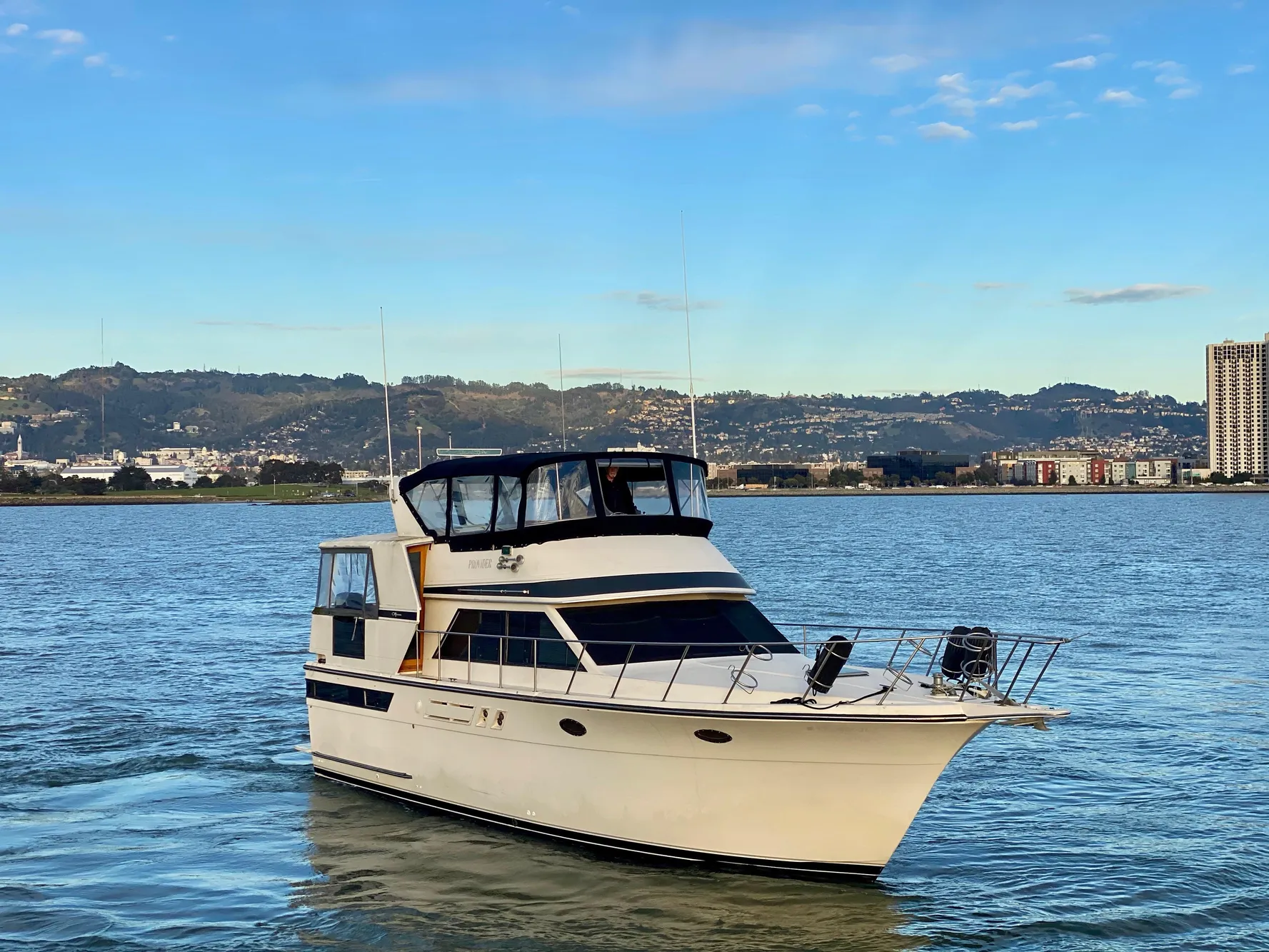 1988 Californian Sundeck Motoryacht cruising on a scenic waterway.