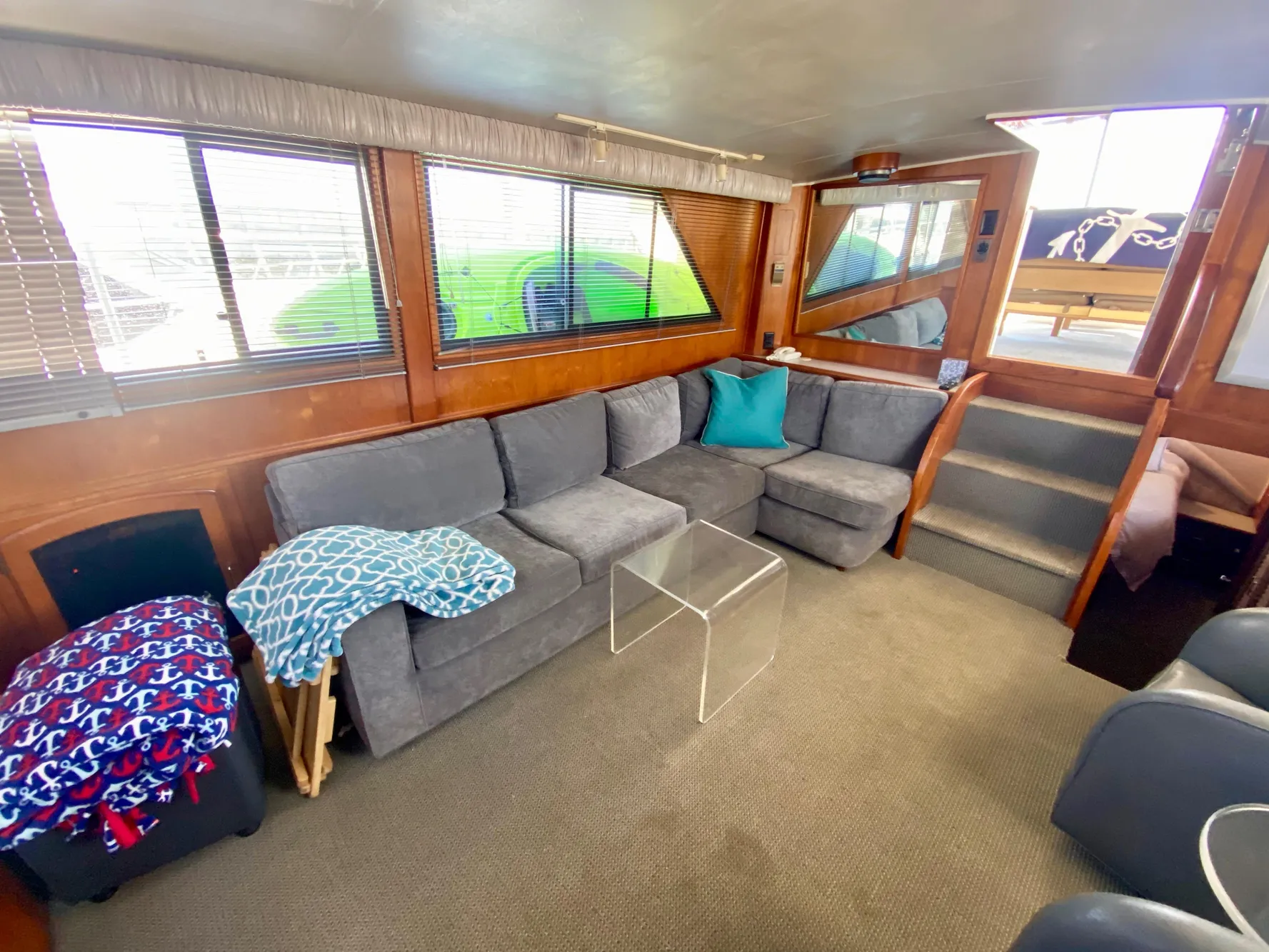 1988 Californian Sundeck Motoryacht interior with cozy seating, glass table, and nautical decor.