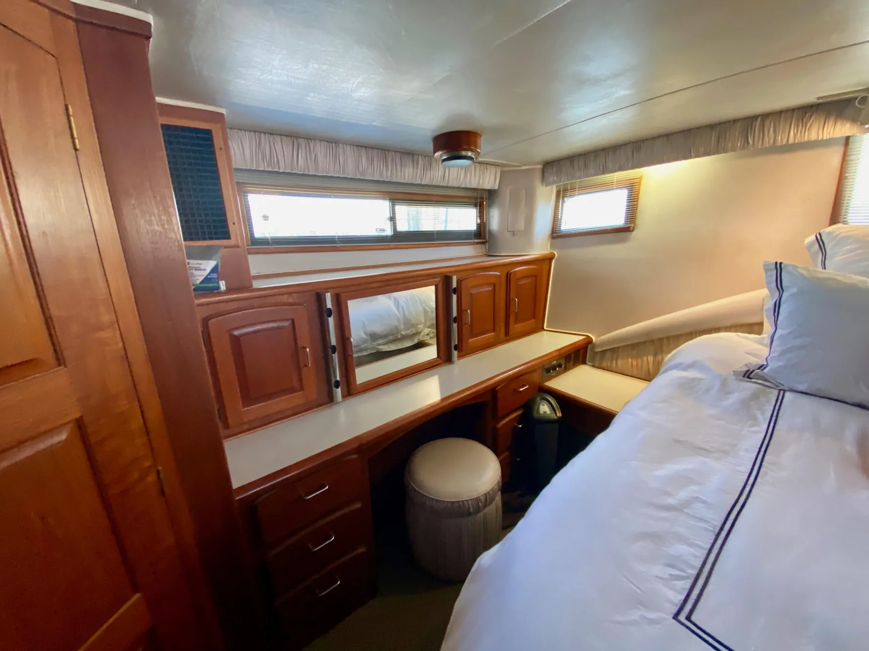 1988 Californian Sundeck Motoryacht interior with wooden cabinetry and cozy bedding.