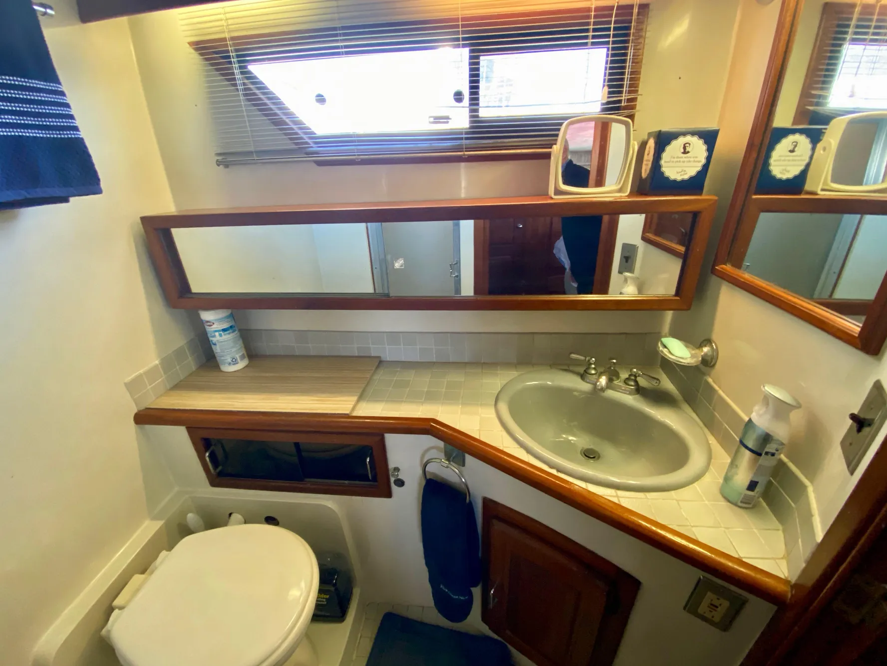 1988 Californian Sundeck Motoryacht bathroom with sink, mirror, and toilet.