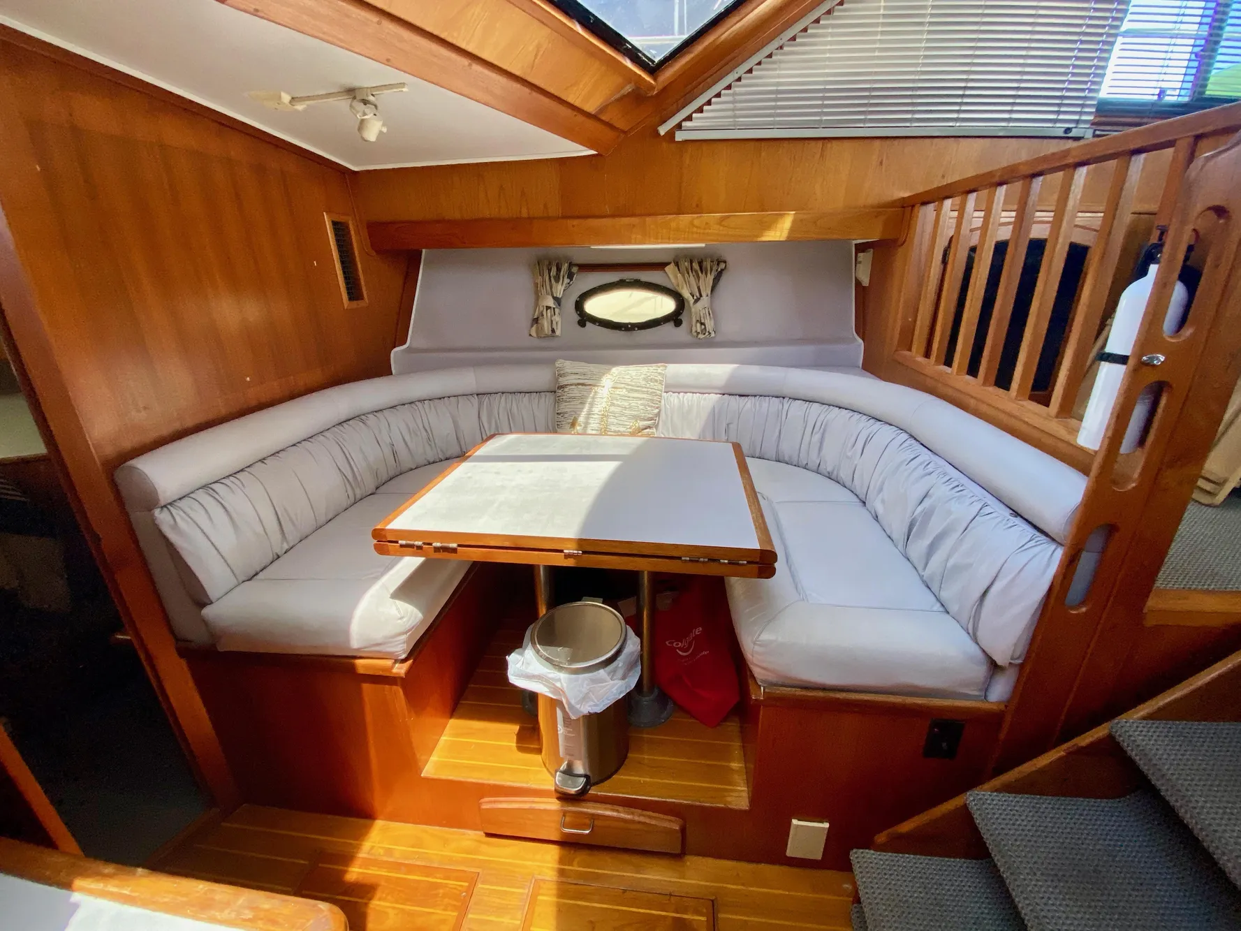 1988 Californian Sundeck Motoryacht interior with cozy dining area and wooden accents.