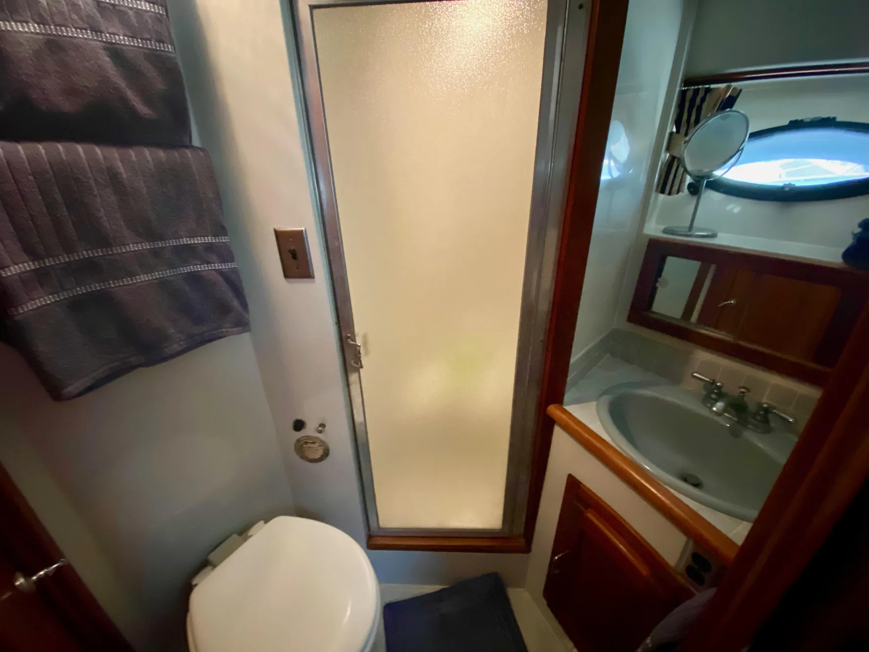 1988 Californian Sundeck Motoryacht bathroom with shower, sink, and toilet.