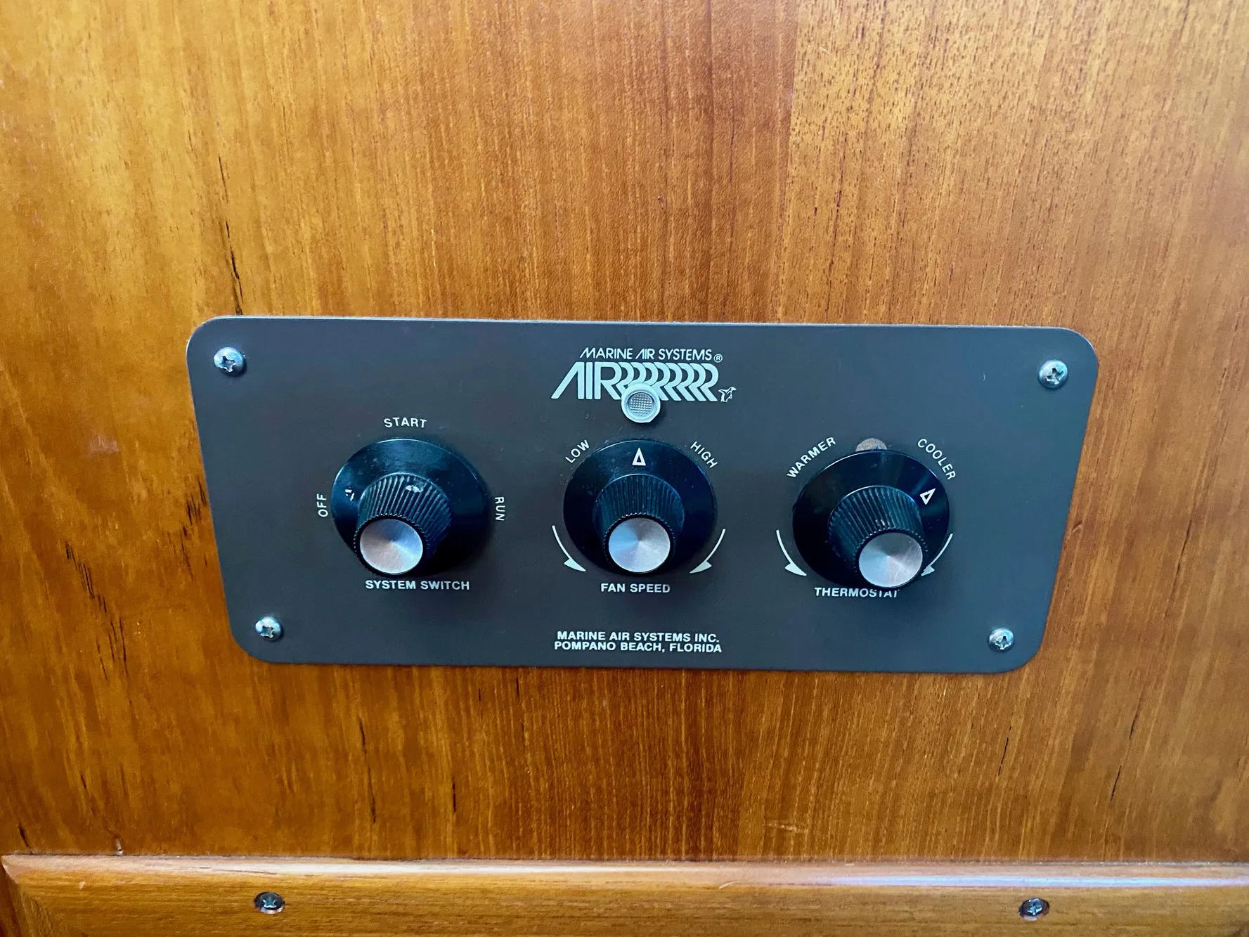 Control panel of 1988 Californian Sundeck Motoryacht, featuring system switch, fan speed, and thermostat.