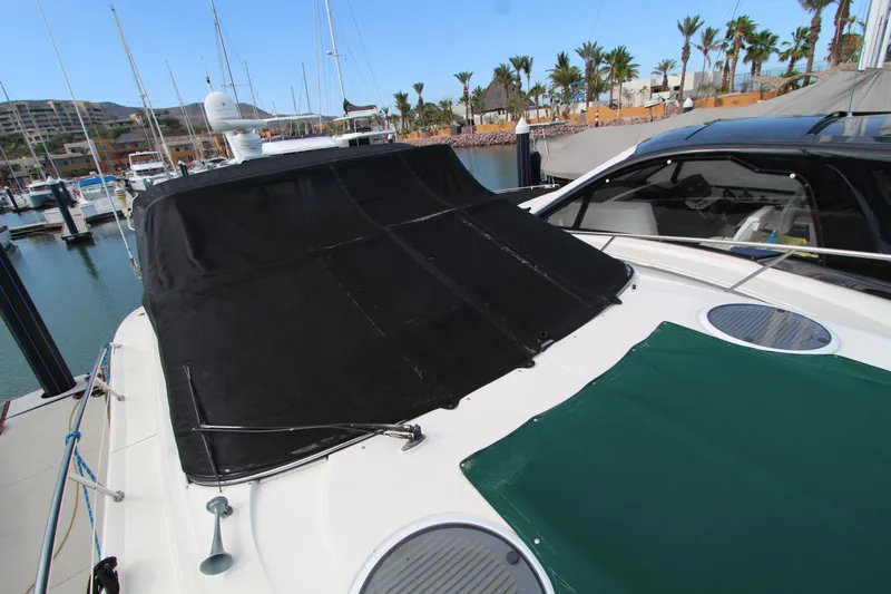  Yacht Photos Pics 2002 Regal Commodore 4260 yacht docked at marina with black and green covers.