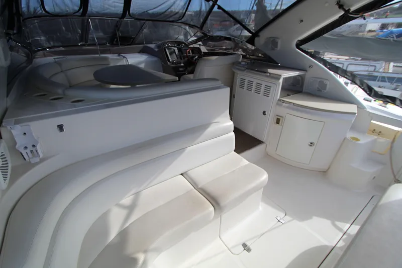  Yacht Photos Pics Interior of 2002 Regal Commodore 4260 yacht with seating and control panel.