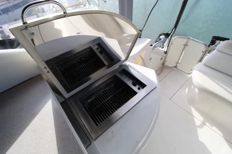  Yacht Photos Pics Outdoor grill on 2002 Regal Commodore 4260 yacht deck, open lid, sunny day.