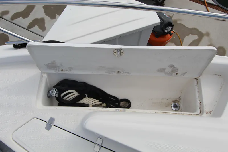 Yacht Photos Pics Open storage compartment on 2002 Regal Commodore 4260 boat, containing coiled rope.