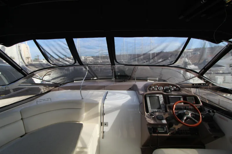  Yacht Photos Pics 2002 Regal Commodore 4260 yacht cockpit with steering wheel and navigation instruments.