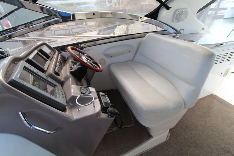  Yacht Photos Pics 2002 Regal Commodore 4260 helm with leather seating and advanced navigation controls.