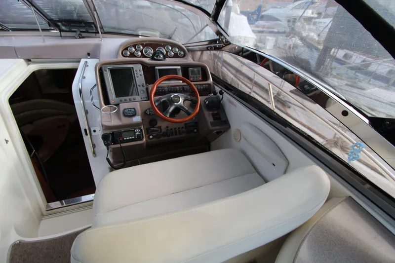  Yacht Photos Pics Cockpit of 2002 Regal Commodore 4260 yacht with steering wheel and navigation instruments.