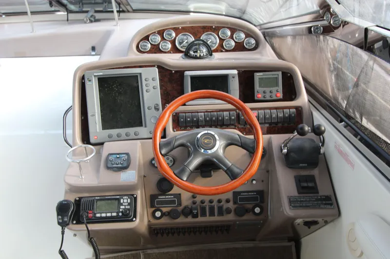  Yacht Photos Pics Cockpit of 2002 Regal Commodore 4260 with steering wheel, navigation screens, and control panels.