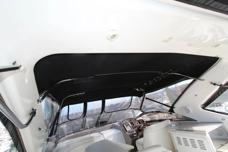  Yacht Photos Pics Interior view of 2002 Regal Commodore 4260 yacht cockpit with black canopy.