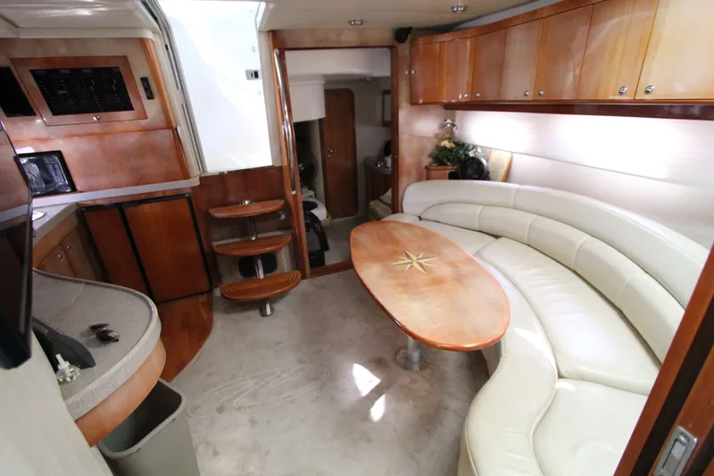  Yacht Photos Pics Luxurious interior of 2002 Regal Commodore 4260 yacht with curved seating and wooden accents.