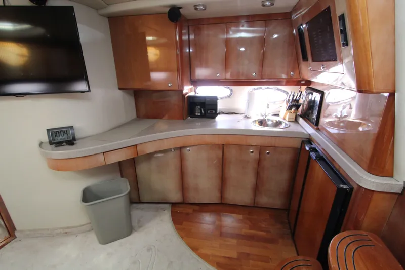  Yacht Photos Pics 2002 Regal Commodore 4260 yacht interior kitchen with wood cabinets and modern appliances.