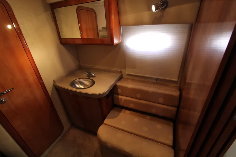  Yacht Photos Pics 2002 Regal Commodore 4260 yacht interior with sink, seating, and wooden cabinetry.