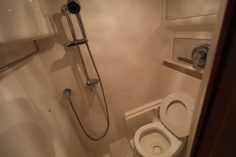  Yacht Photos Pics Compact bathroom in 2002 Regal Commodore 4260 yacht with shower and toilet.