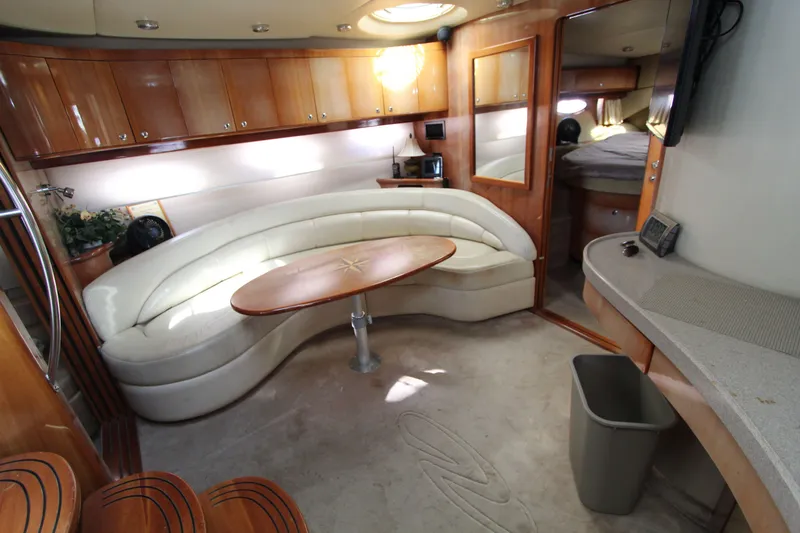  Yacht Photos Pics Luxurious interior of 2002 Regal Commodore 4260 yacht with elegant seating and wood finishes.