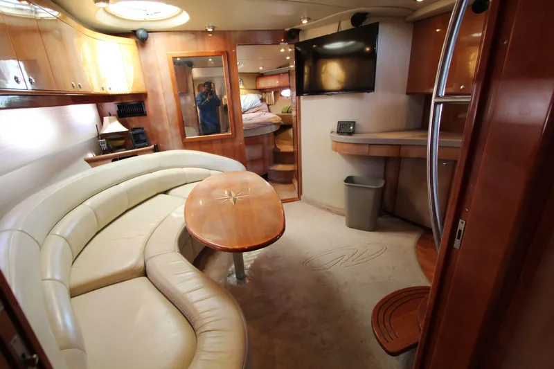  Yacht Photos Pics Luxurious interior of 2002 Regal Commodore 4260 yacht with curved seating and wooden finishes.
