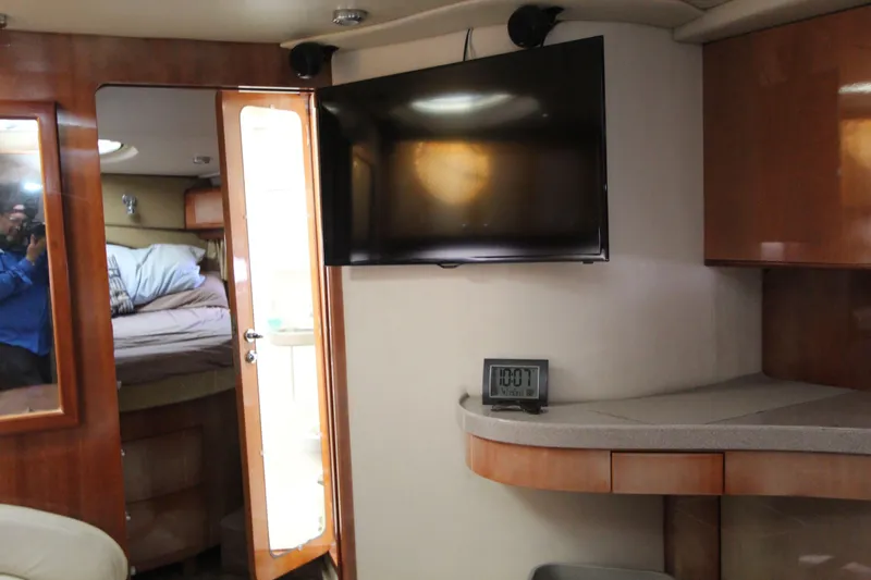  Yacht Photos Pics Interior of 2002 Regal Commodore 4260 yacht with TV, clock, and bedroom view.