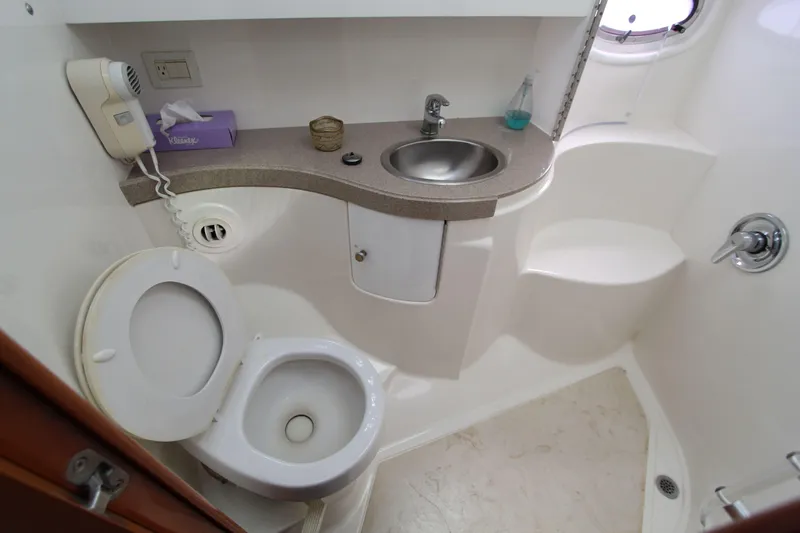 Yacht Photos Pics Bathroom in 2002 Regal Commodore 4260 yacht with toilet, sink, and shower.