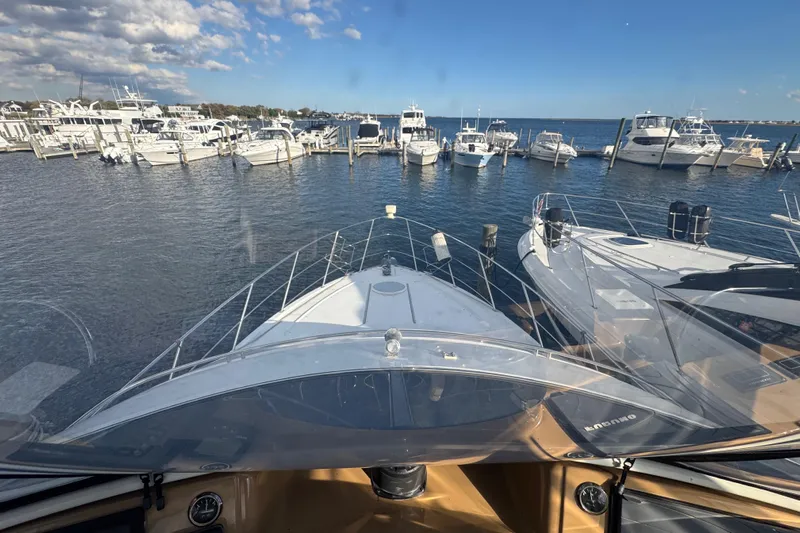 Coral Dreams Yacht Photos Pics 2003 Carver 444 Cockpit Motor Yacht docked at a marina with clear blue skies.