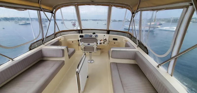 Pathfinder Yacht Photos Pics 2004 Mainship 400 Trawler helm with panoramic water views and comfortable seating.
