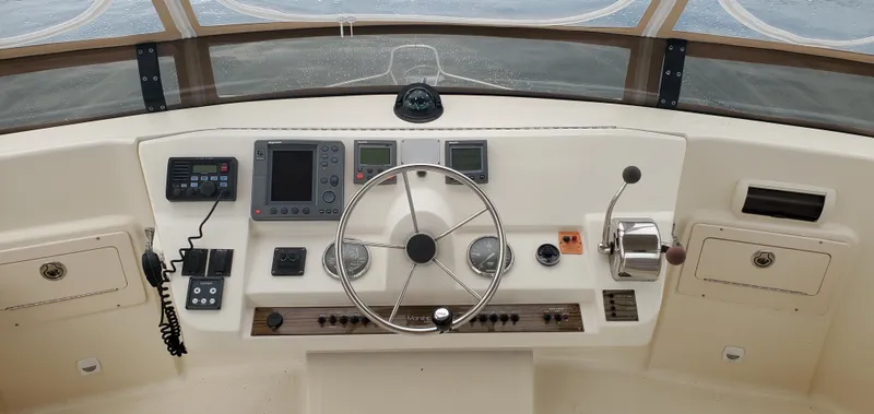 Pathfinder Yacht Photos Pics 2004 Mainship 400 Trawler helm with steering wheel, navigation instruments, and control panel.