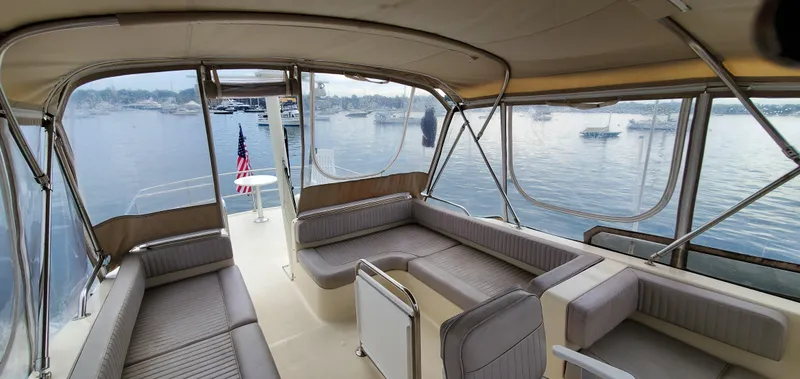 Pathfinder Yacht Photos Pics 2004 Mainship 400 Trawler interior with spacious seating, overlooking a serene waterfront view.