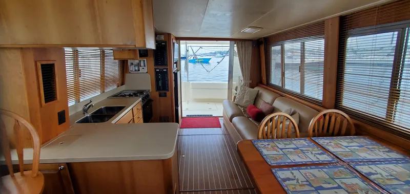 Pathfinder Yacht Photos Pics Interior of 2004 Mainship 400 Trawler with kitchen, dining area, and ocean view.