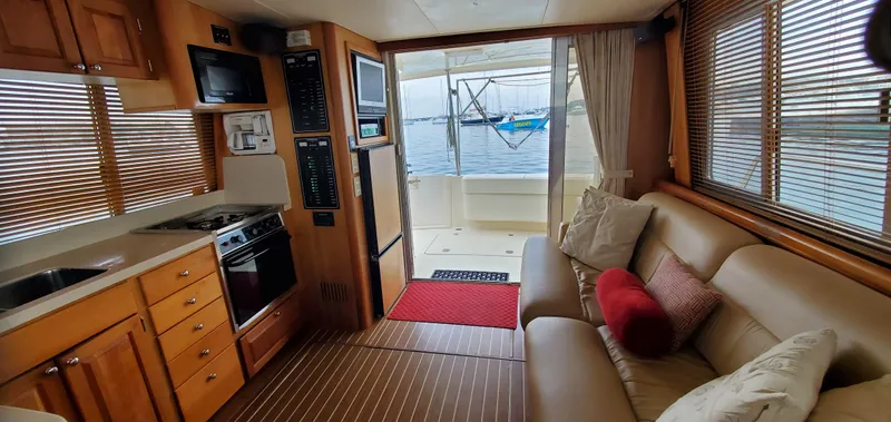 Pathfinder Yacht Photos Pics Interior of 2004 Mainship 400 Trawler with cozy seating and kitchen, overlooking marina.