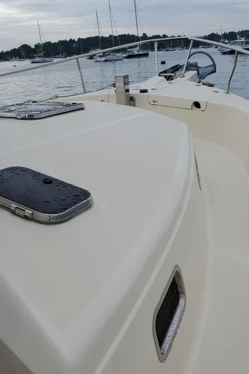 Pathfinder Yacht Photos Pics 2004 Mainship 400 Trawler on calm water, showcasing deck and railing details.