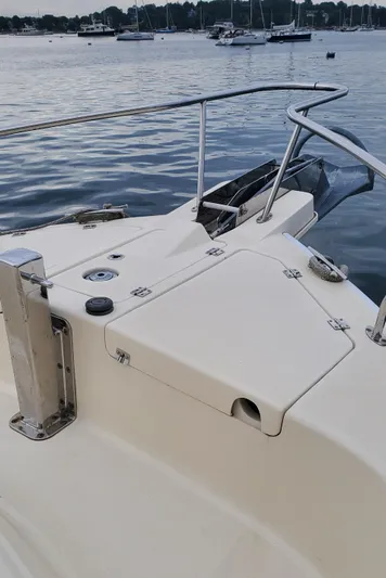 Pathfinder Yacht Photos Pics 2004 Mainship 400 Trawler deck with railing, docked on calm water.