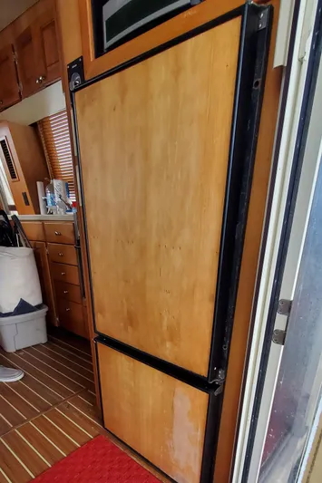 Pathfinder Yacht Photos Pics 2004 Mainship 400 Trawler interior with wooden cabinetry and flooring.