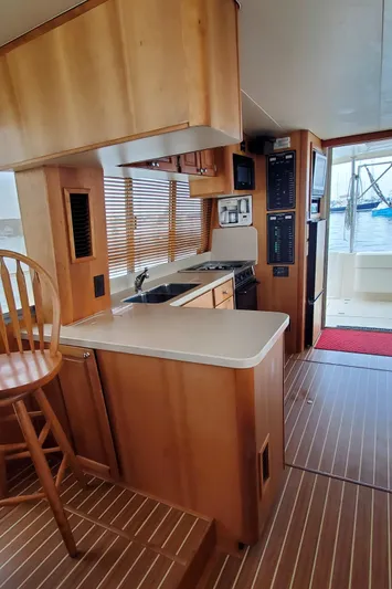 Pathfinder Yacht Photos Pics 2004 Mainship 400 Trawler interior with wooden cabinetry and modern kitchen amenities.