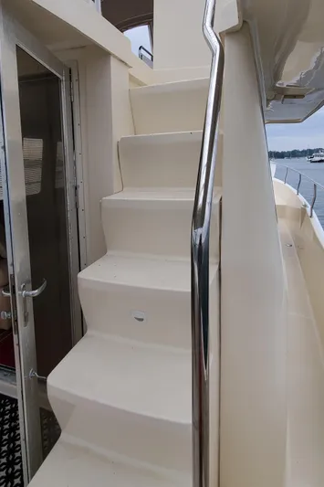 Pathfinder Yacht Photos Pics Staircase on 2004 Mainship 400 Trawler with stainless steel railing, leading to upper deck.