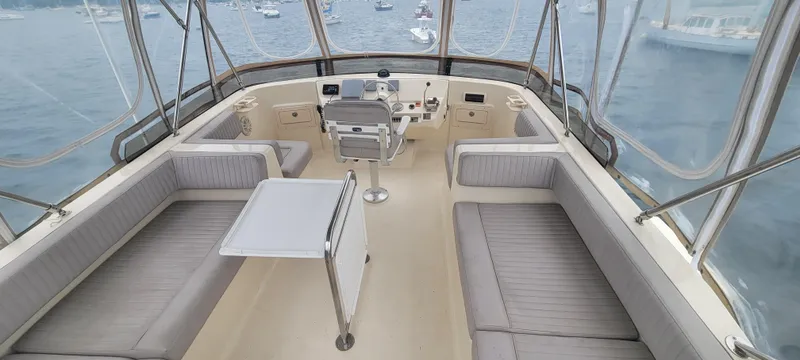 Pathfinder Yacht Photos Pics 2004 Mainship 400 Trawler interior with seating and helm, overlooking a marina.