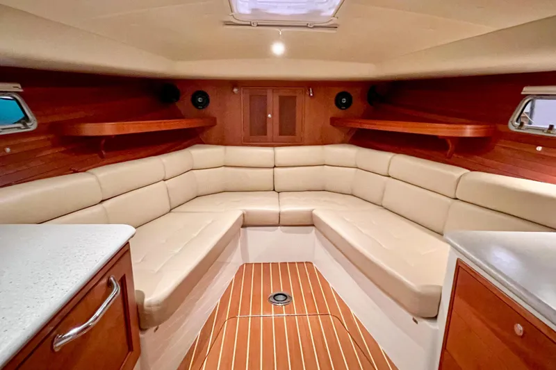  Yacht Photos Pics 2009 MJM 34z Downeast boat interior with beige seating and wooden accents.