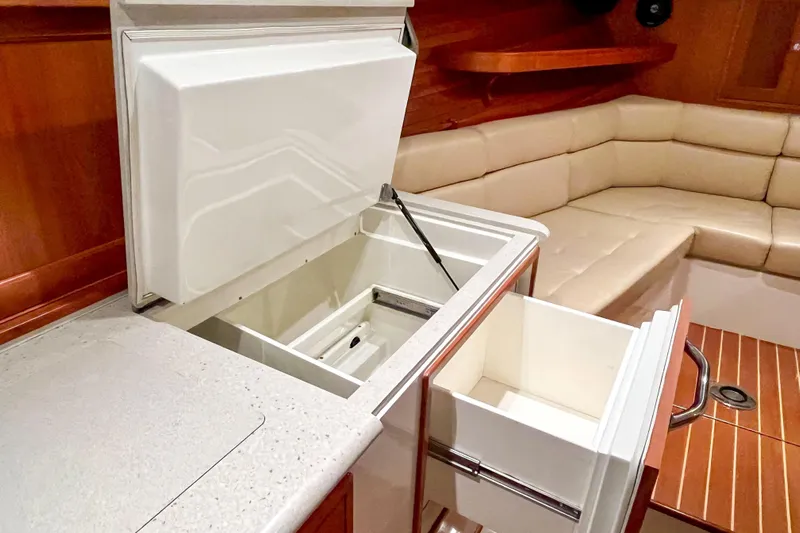  Yacht Photos Pics 2009 MJM 34z Downeast yacht interior with open storage and beige seating area.