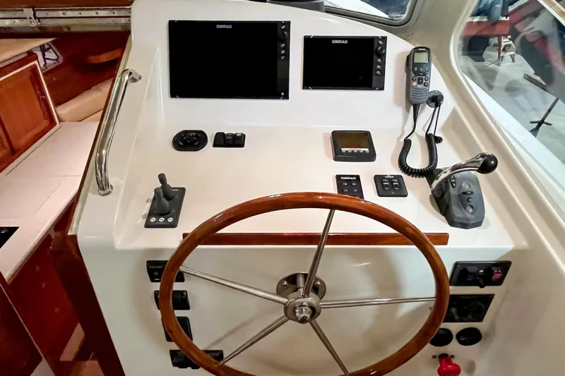  Yacht Photos Pics 2009 MJM 34z Downeast helm with wooden wheel and navigation controls.