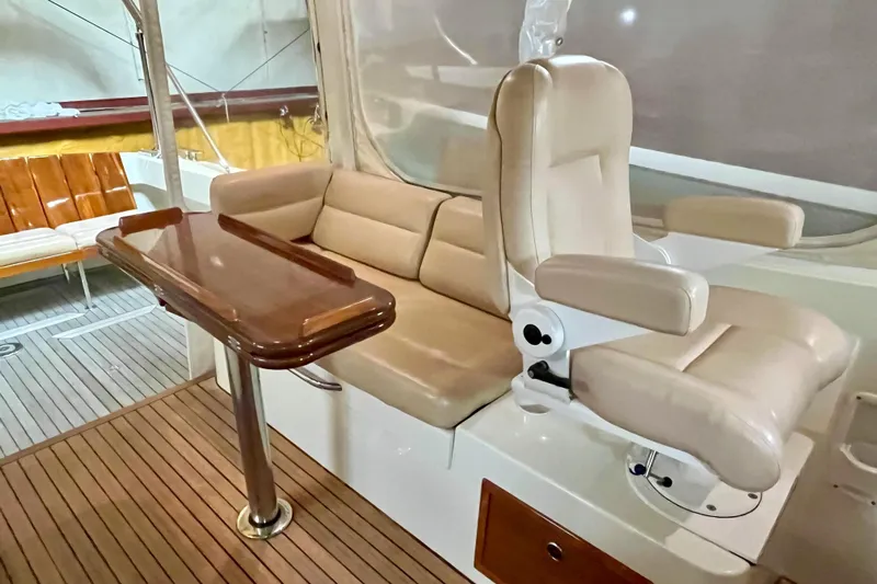  Yacht Photos Pics 2009 MJM 34z Downeast boat interior with beige seating and wooden table.