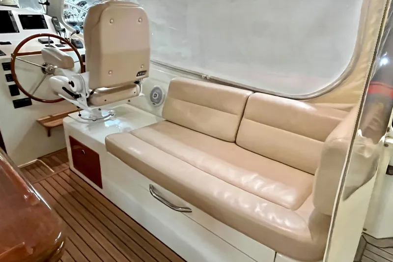  Yacht Photos Pics 2009 MJM 34z Downeast boat interior with beige seating and wooden flooring.