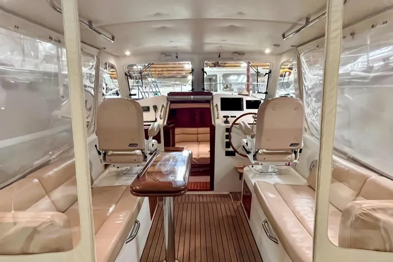  Yacht Photos Pics 2009 MJM 34z Downeast boat interior with leather seating and wooden accents.