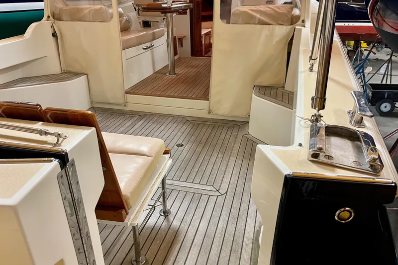  Yacht Photos Pics 2009 MJM 34z Downeast boat interior with teak flooring and cushioned seating.