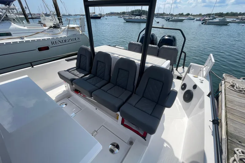  Yacht Photos Pics 2020 Axopar 37 SUN TOP BRABUS boat with seating, docked in a marina.