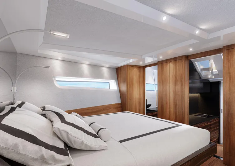Fiart P48 Yacht Photos Pics Luxurious cabin interior of 2025 Fiart P52 yacht with modern wood finishes and elegant bedding.