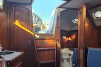 Interior of a 1999 Custom Enter Explicite 360 yacht with wooden finish and skylight.
