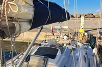 Sailboat docked at marina, Custom Enter Explicite 360, 1999 model, with clear blue sky.