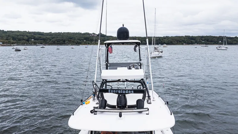  Yacht Photos Pics 2017 Everglades 435 CC boat on a lake with distant shoreline and cloudy sky.