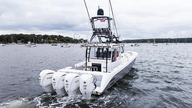  Yacht Photos Pics 2017 Everglades 435 CC boat with four engines cruising on a lake.