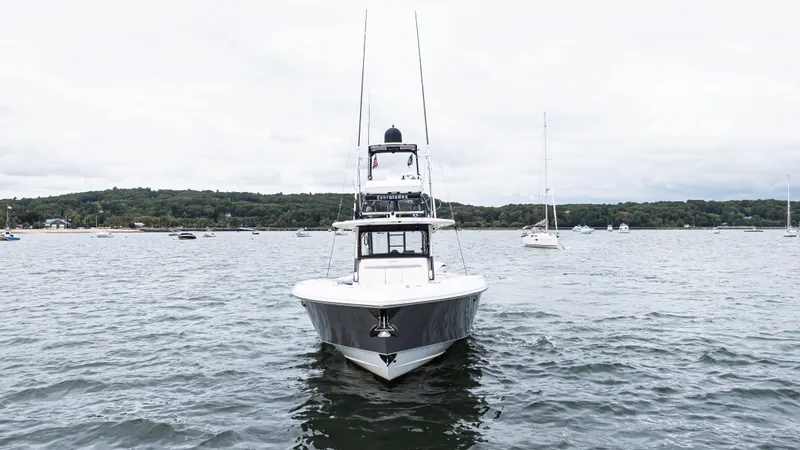  Yacht Photos Pics 2017 Everglades 435 CC boat on a calm lake with distant shoreline.